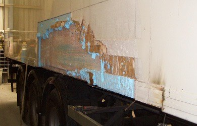 view of a lorry trailer with damaged sides
